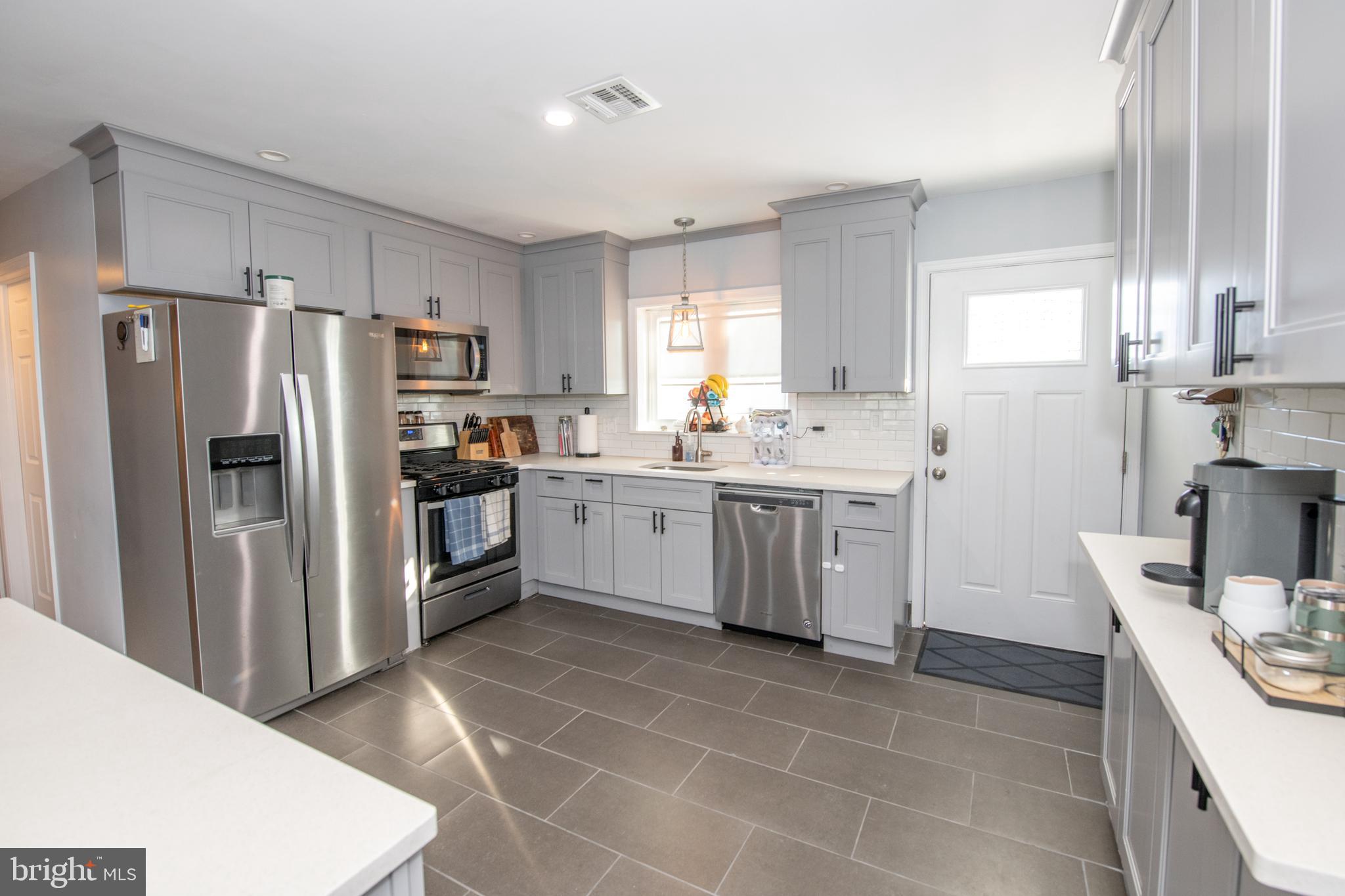 9304 Treaty Road Philadelphia, PA 19114 - Photo 12 of 43 a kitchen with a sink a counter top space stainless steel appliances and cabinets