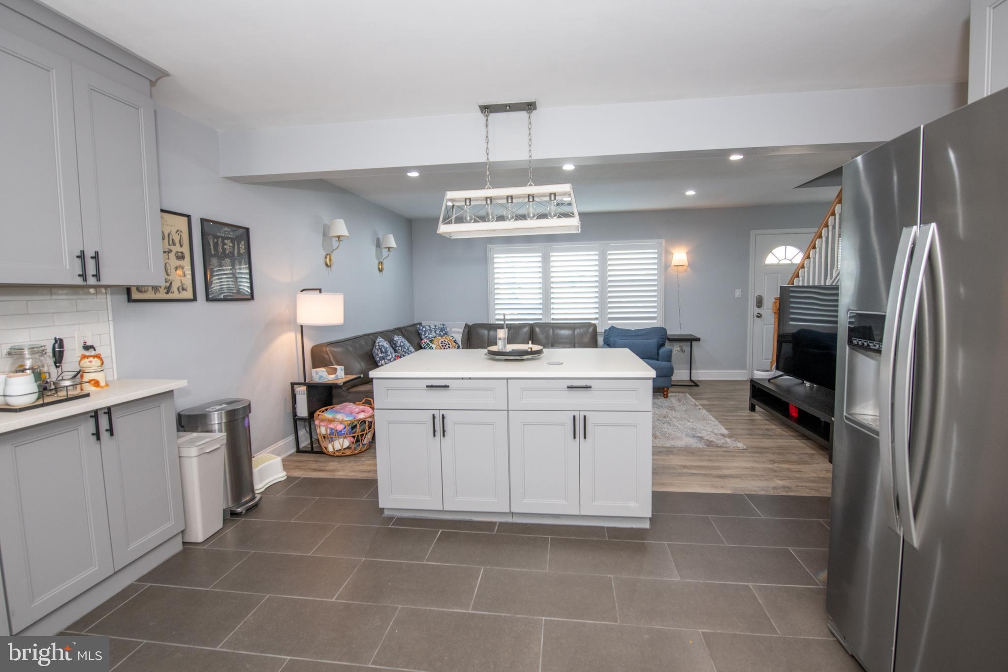 9304 Treaty Road Philadelphia, PA 19114 - Photo 13 of 43 a room with kitchen island a sink stainless steel appliances and cabinets