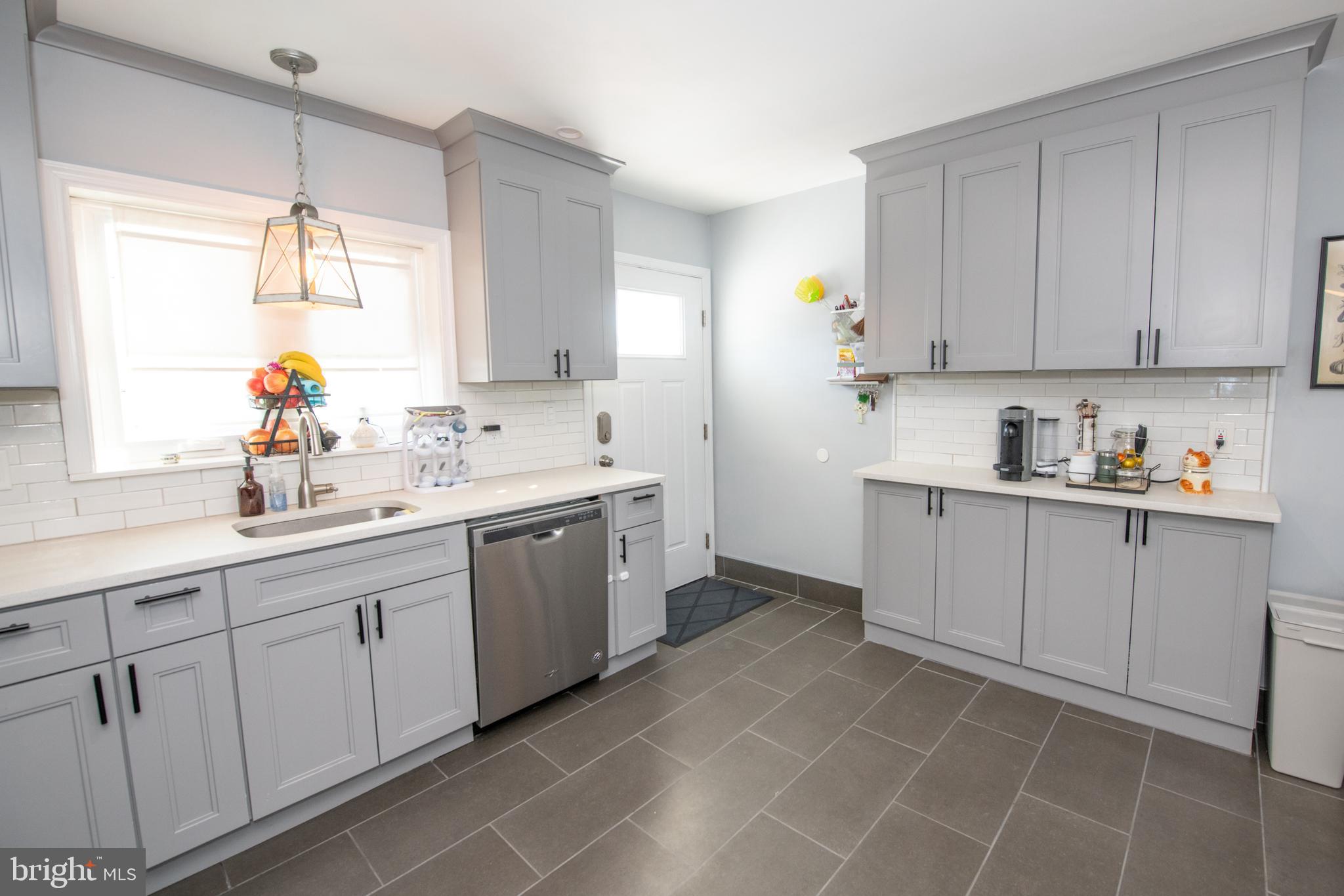 9304 Treaty Road Philadelphia, PA 19114 - Photo 16 of 43 a kitchen with a sink window and cabinets