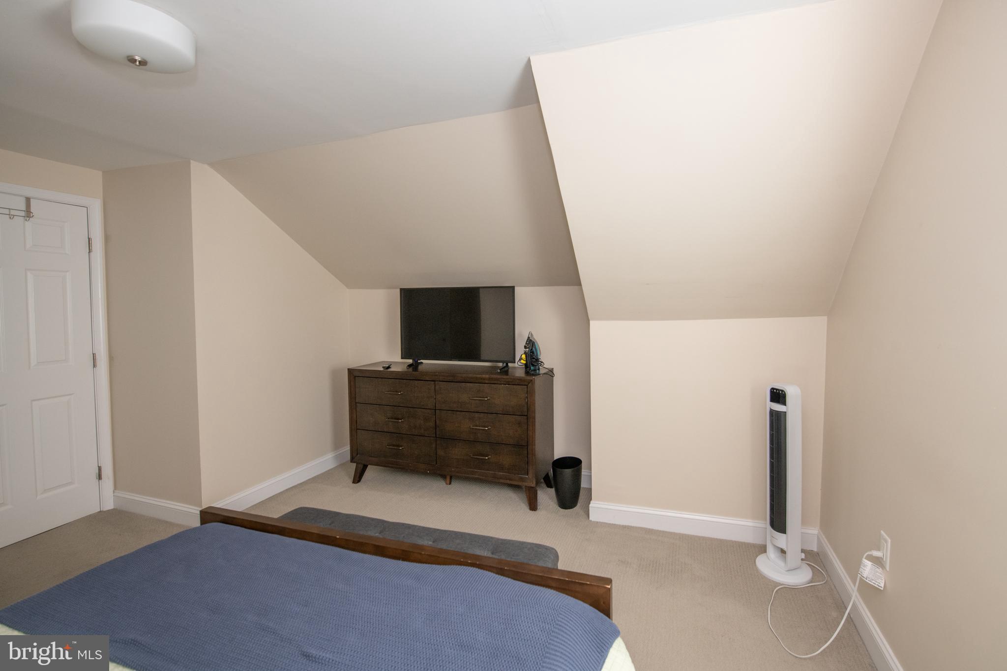 9304 Treaty Road Philadelphia, PA 19114 - Photo 27 of 43 a living room with a bed furniture and a flat screen tv