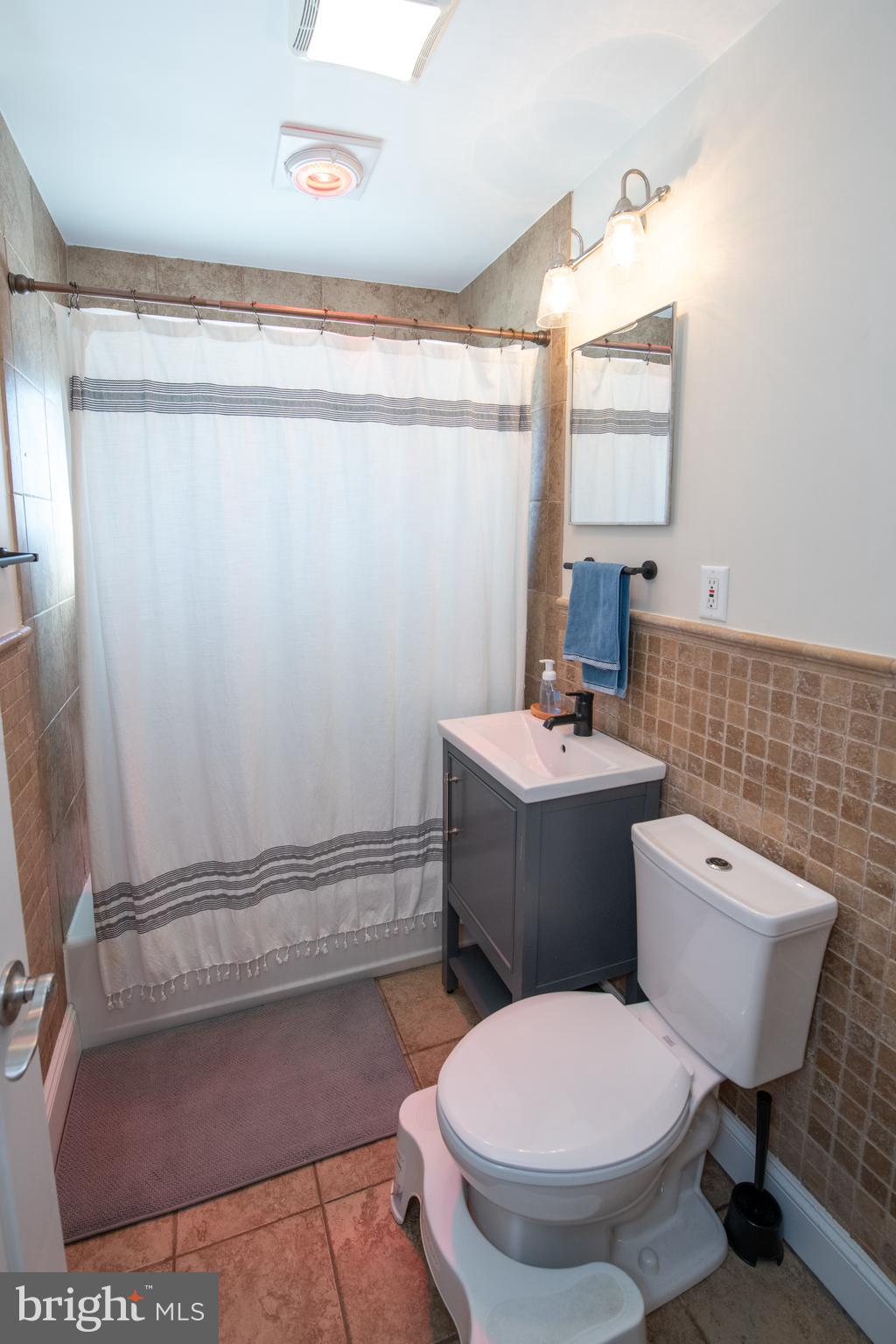 9304 Treaty Road Philadelphia, PA 19114 - Photo 29 of 43 a bathroom with a toilet a sink and a mirror
