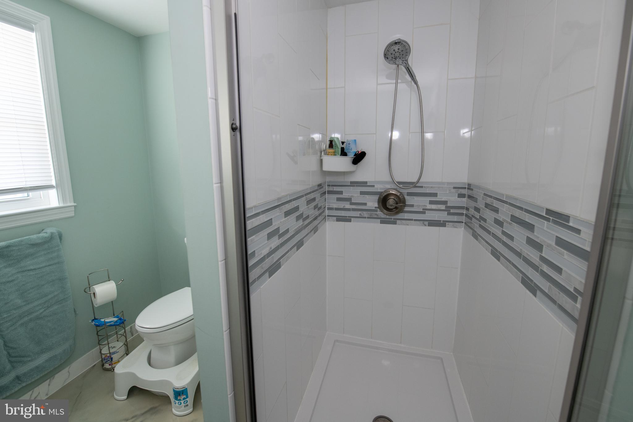 9304 Treaty Road Philadelphia, PA 19114 - Photo 35 of 43 a bathroom with a sink a toilet and a mirror