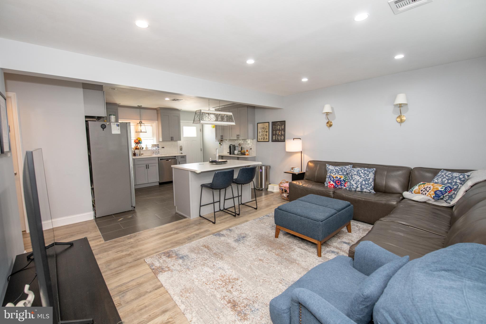9304 Treaty Road Philadelphia, PA 19114 - Photo 6 of 43 a living room with furniture a refrigerator and a flat screen tv