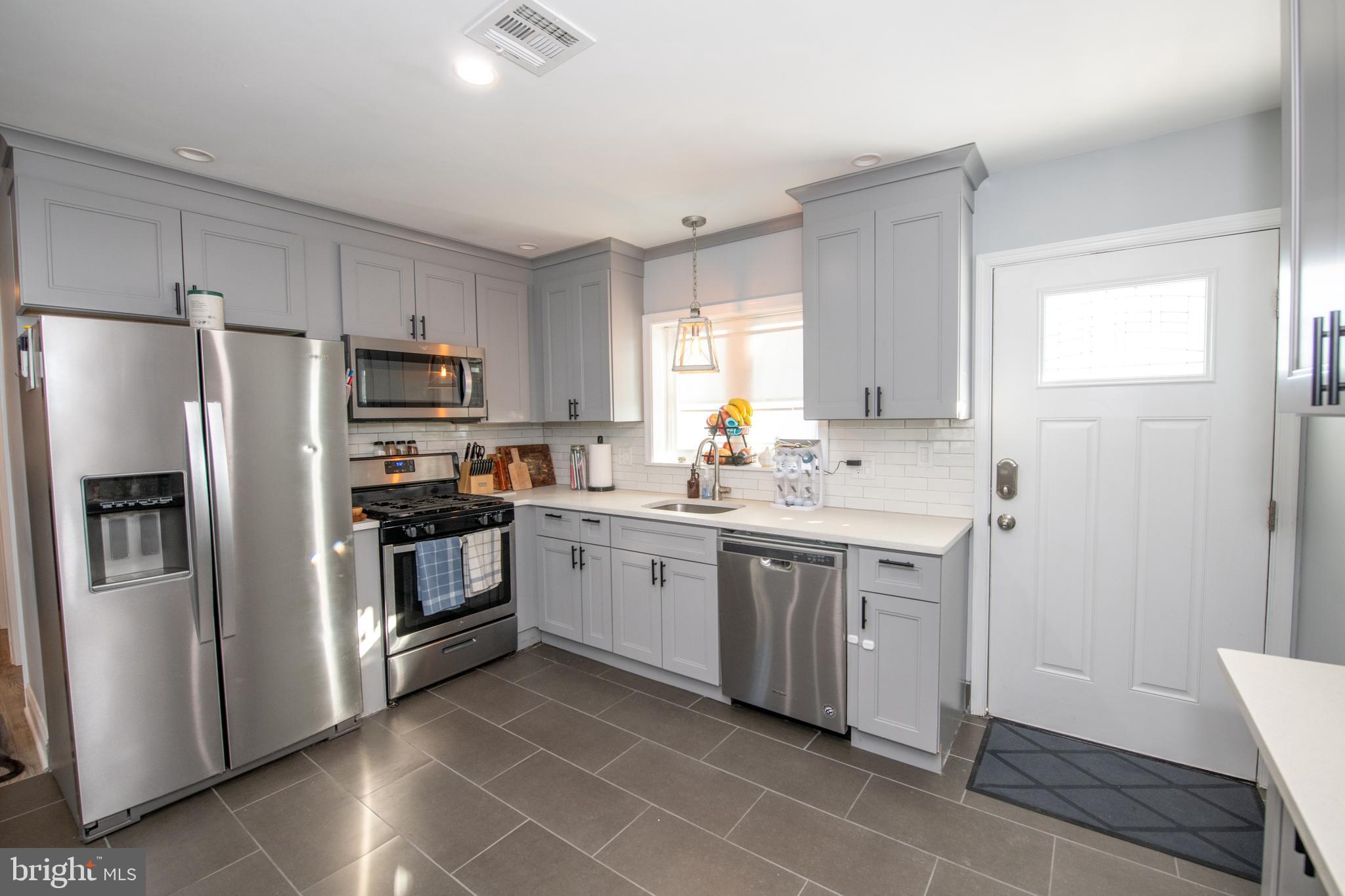 9304 Treaty Road Philadelphia, PA 19114 - Photo 10 of 43 a kitchen with sink a microwave and refrigerator