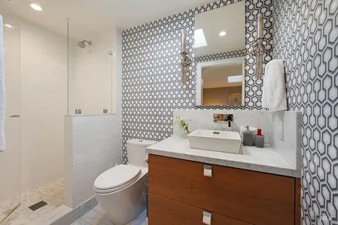 a bathroom with a mirror and a shower