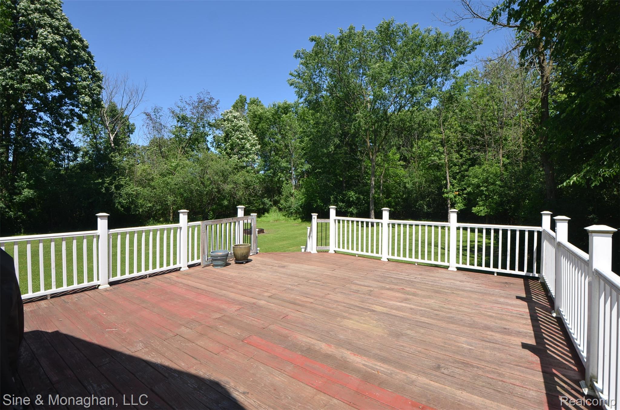 76152 Burman Road Richmond, MI 48062 - Photo 72 of 75 Spacious wood deck featuring white railing, overlooking a verdant lawn and mature trees