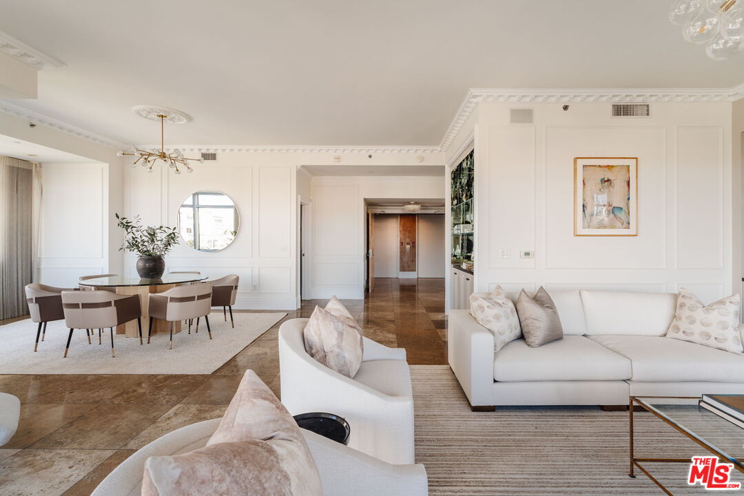 10800 Wilshire Boulevard, Unit 502 Los Angeles, CA 90024 - Photo 12 of 29 a living room with furniture and a dining table