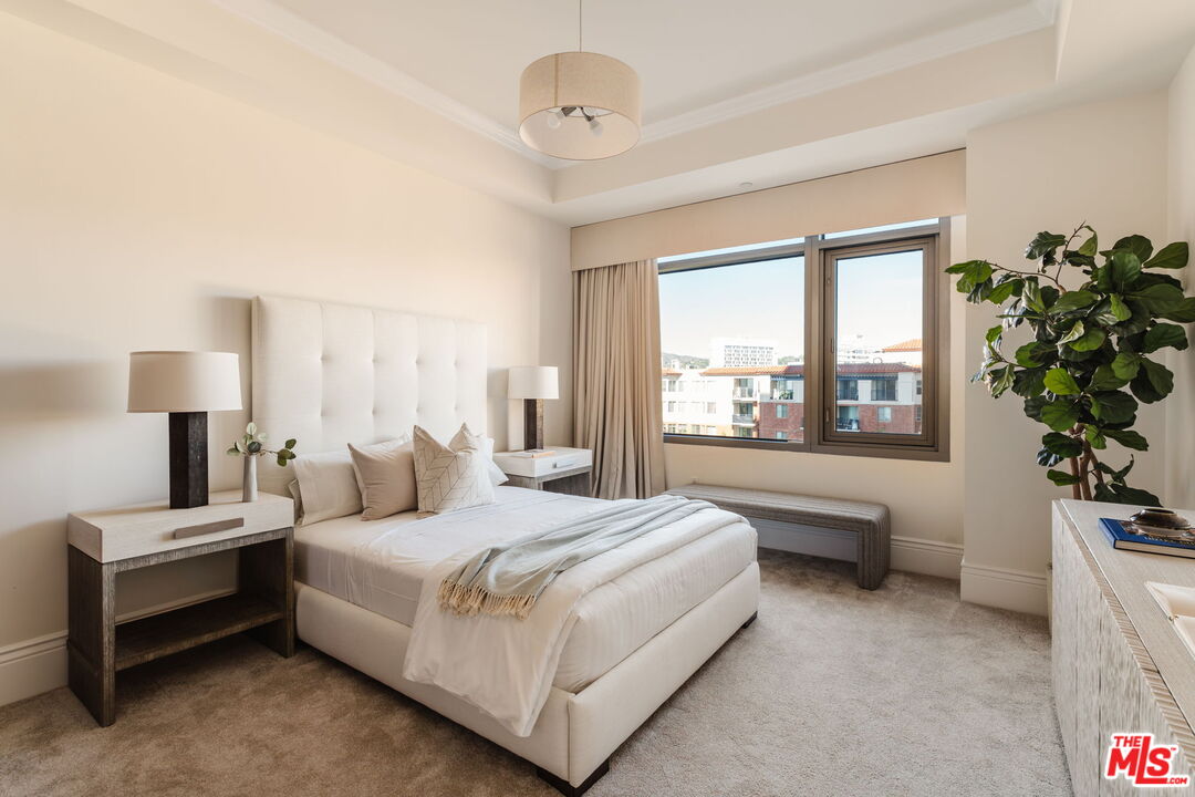 10800 Wilshire Boulevard, Unit 502 Los Angeles, CA 90024 - Photo 18 of 29 a bedroom with a large bed and a large window