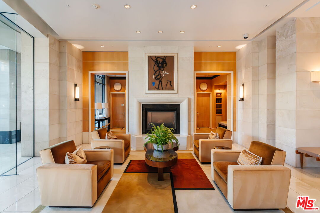 10800 Wilshire Boulevard, Unit 502 Los Angeles, CA 90024 - Photo 20 of 29 a living room with furniture potted plant and a fireplace