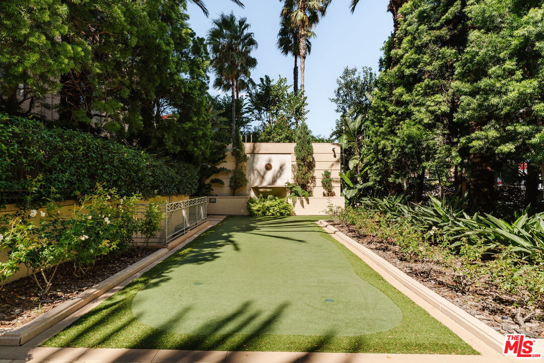 10800 Wilshire Boulevard, Unit 502 Los Angeles, CA 90024 - Photo 24 of 29 a view of a swimming pool with a bench and trees in the background