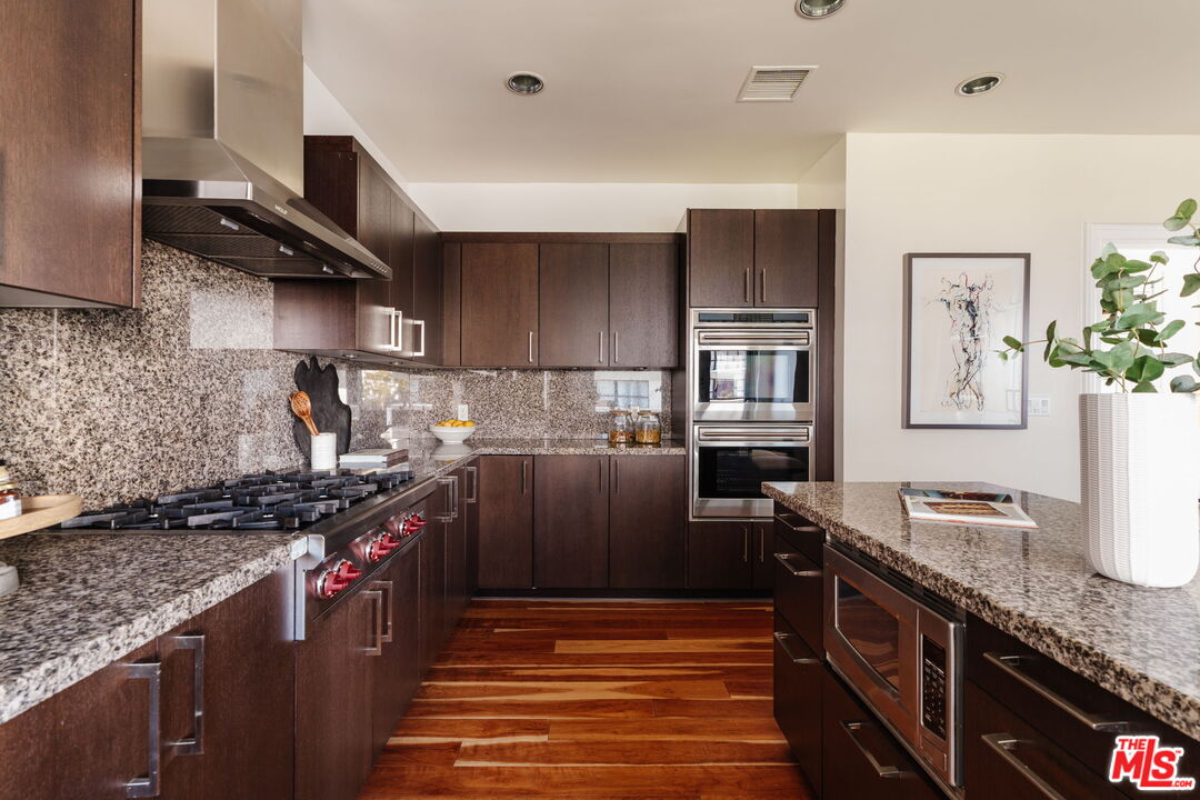10800 Wilshire Boulevard, Unit 502 Los Angeles, CA 90024 - Photo 9 of 29 a kitchen with granite countertop a sink stove and refrigerator