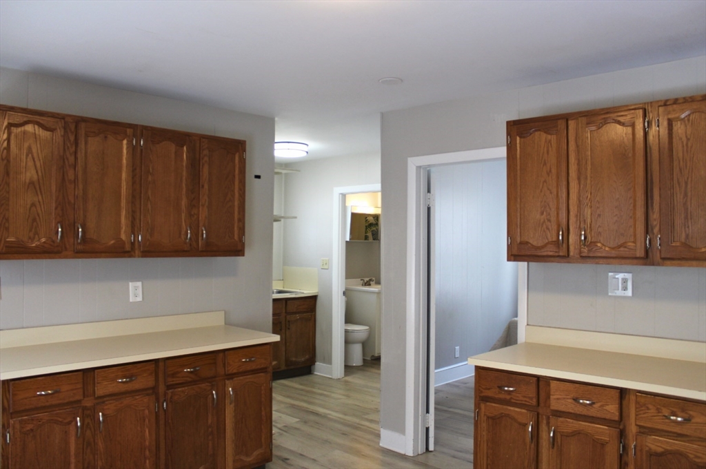 4 Northend Street, Unit 1 Peabody, MA 01960 - Photo 1 of 11 a kitchen with a refrigerator and cabinets
