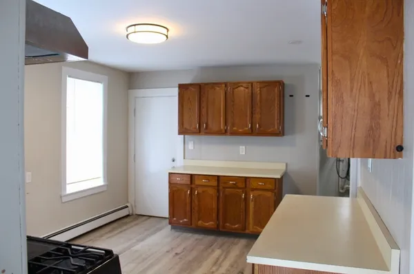 a kitchen with a cabinets and wooden floor