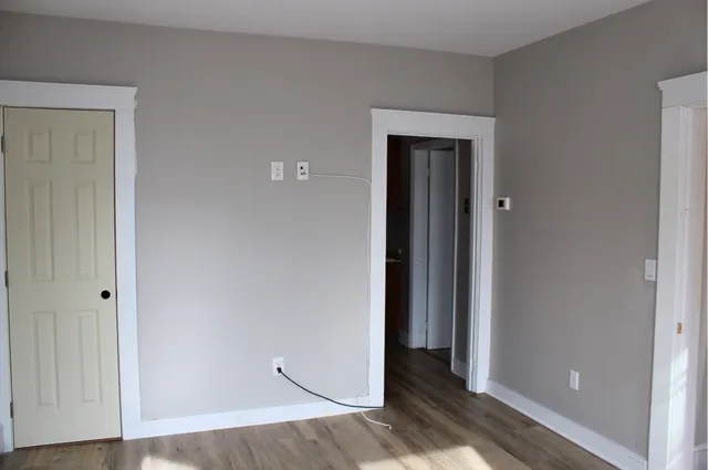 a view of a room with wooden floor