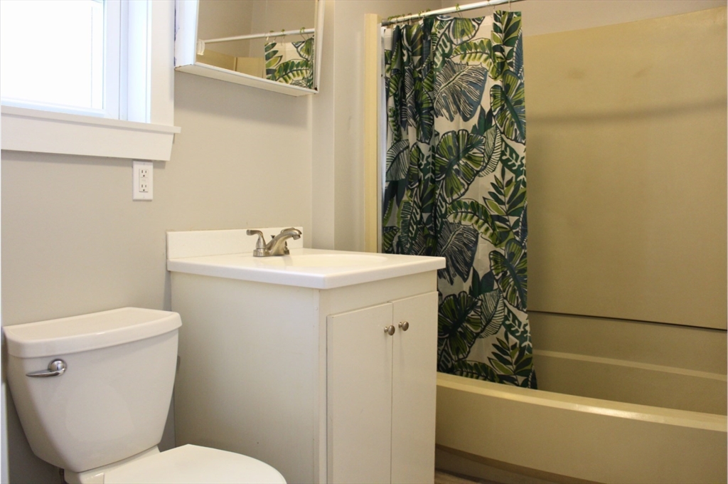4 Northend Street, Unit 1 Peabody, MA 01960 - Photo 8 of 11 a bathroom with a sink and a toilet
