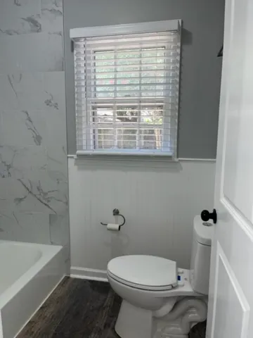 a bathroom with a toilet a sink and bathtub