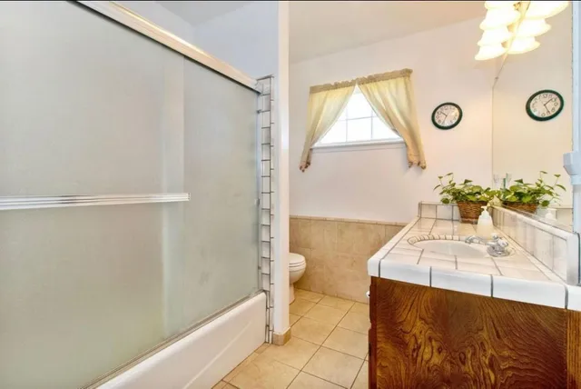 a bathroom with a sink a toilet and tub