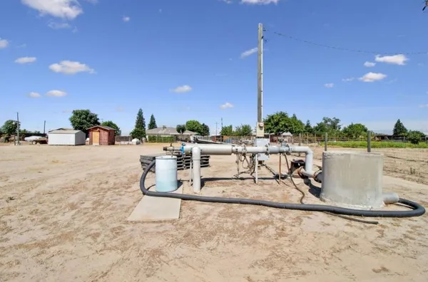 a view of a lake with a table and chairs