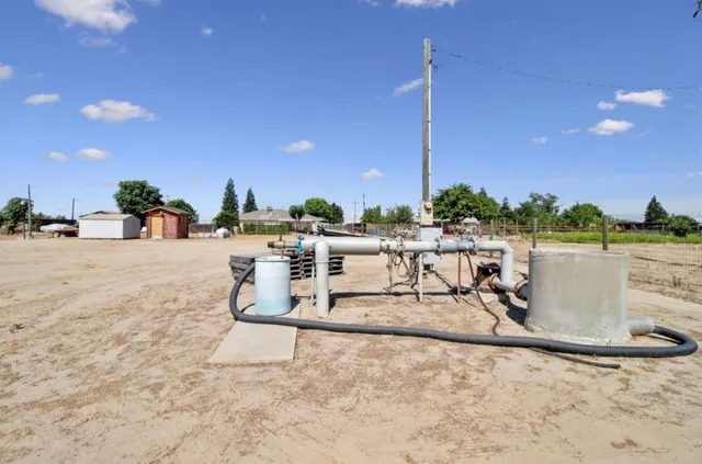 a view of a lake with a table and chairs
