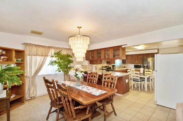 a view of a dining room with furniture and chandelier