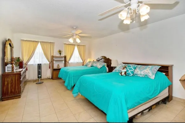 a bedroom with two beds and a chandelier