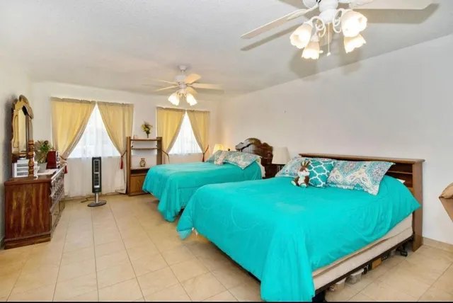 a bedroom with two beds and a chandelier