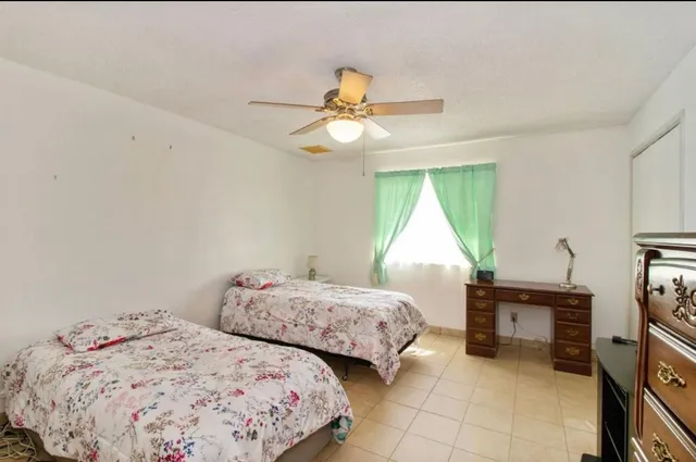 a bedroom with two beds and a chandelier