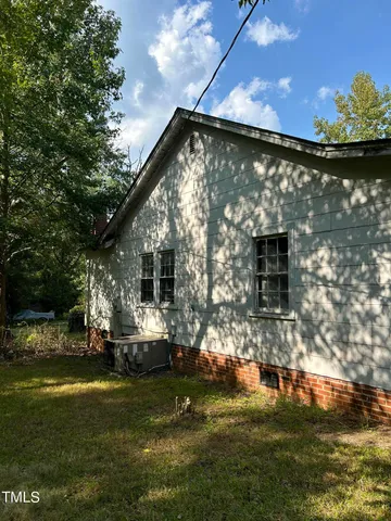 a view of a back yard of the house with green space