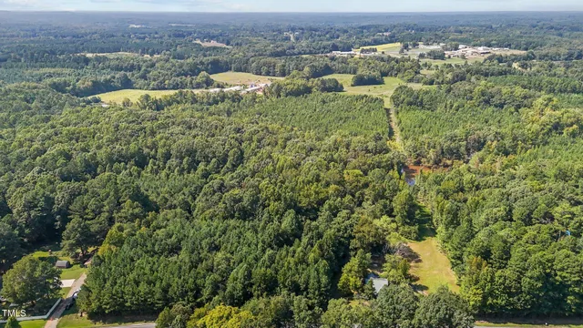 an aerial view of residential houses with outdoor and green space
