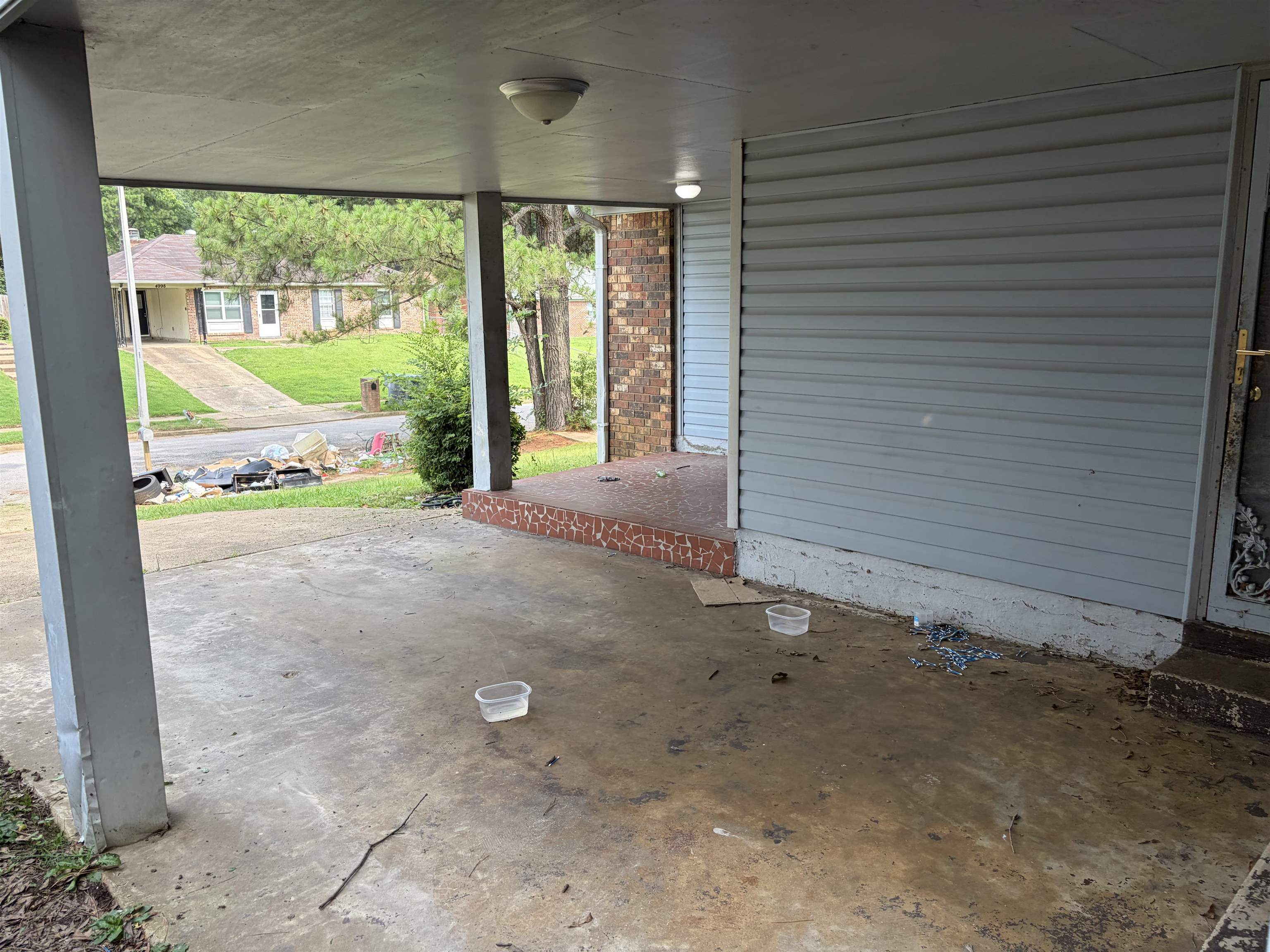 4993 Cedar View Road Memphis, TN 38118 - Photo 3 of 23 Covered carport featuring a concrete slab and painted support columns