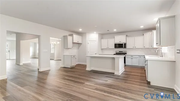 a kitchen with a refrigerator and a stove top oven