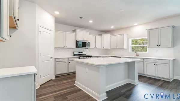 a kitchen with white cabinets and white appliances