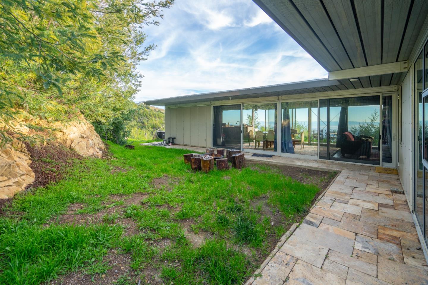 1075 Ormsby Cutoff Watsonville, CA 95076 - Photo 9 of 30 a view of a patio with table and chairs next to a yard