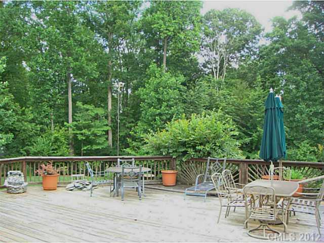 8109 Pine Oak Road Waxhaw, NC 28173 - Photo 13 of 16 a view of a chairs and table on the wooden deck