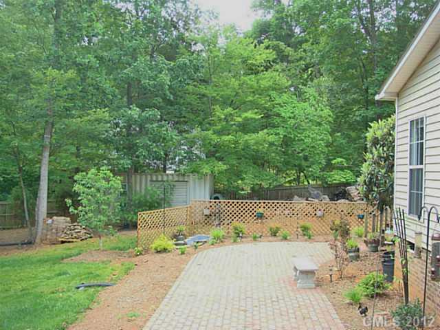 8109 Pine Oak Road Waxhaw, NC 28173 - Photo 15 of 16 a backyard of a house with table and chairs