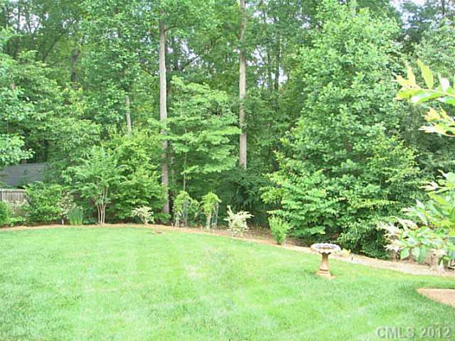 8109 Pine Oak Road Waxhaw, NC 28173 - Photo 16 of 16 a view of a green field with lots of bushes