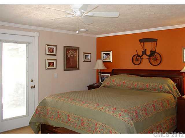 8109 Pine Oak Road Waxhaw, NC 28173 - Photo 6 of 16 a bedroom with a bed and painting on the wall