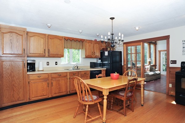 72 Bushy Lane Rutland, MA 01543 - Photo 11 of 29 a kitchen with a dining table chairs and granite counter tops