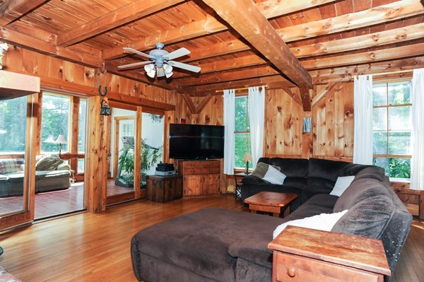 72 Bushy Lane Rutland, MA 01543 - Photo 4 of 29 a living room with furniture a flat screen tv and a large window