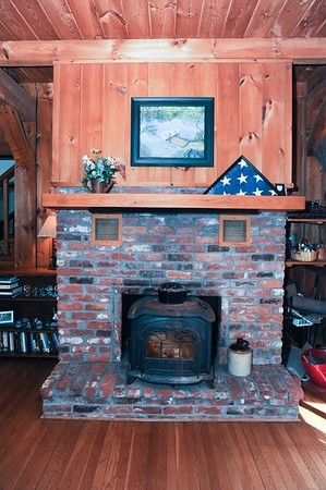 72 Bushy Lane Rutland, MA 01543 - Photo 7 of 29 a fireplace with a clock on top of it