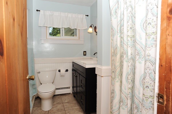 72 Bushy Lane Rutland, MA 01543 - Photo 10 of 29 a bathroom with a sink a toilet and shower curtain