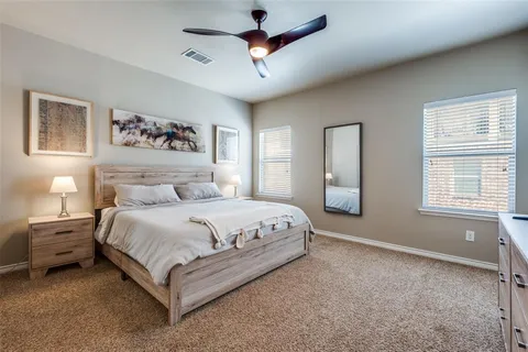 a spacious bedroom with a bed and a window