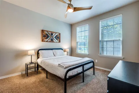 a bedroom with a bed and a night stand