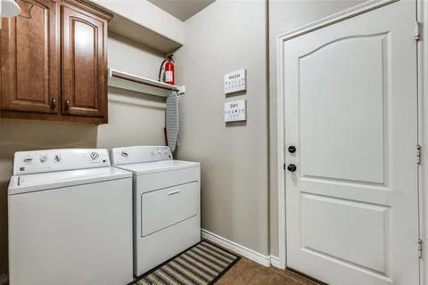 a view of storage and utility room with washer and dryer