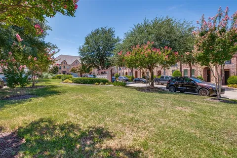 a view of a swimming pool with lawn chairs and plants
