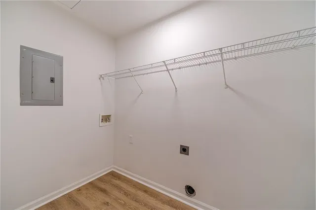 an empty room with ceiling fan and windows