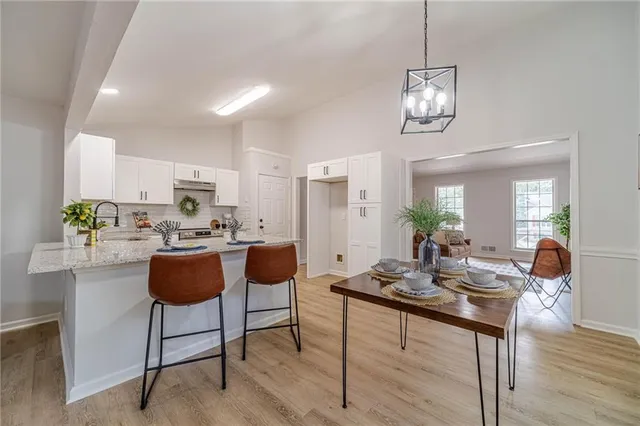 a kitchen with stainless steel appliances white cabinets and a stove top oven