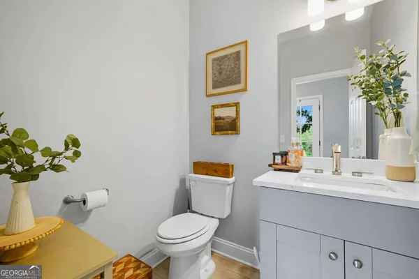 a bathroom with a sink mirror vanity and toilet