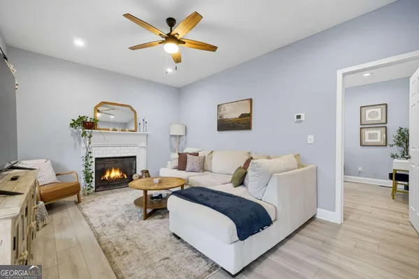 a living room with furniture and a fireplace