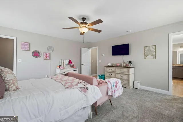 a spacious bedroom with a bed and a chandelier